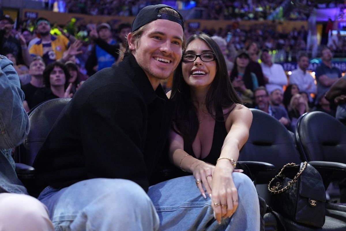 Oct 24, 2025; Los Angeles, California, USA; Los Angeles Chargers quarterback Justin Herbert (left) and girlfriend Madison Beer attend the game between the Minnesota Timberwolves and the Los Angeles Lakers at Crypto.com Arena. Mandatory Credit: Kirby Lee-Imagn Images