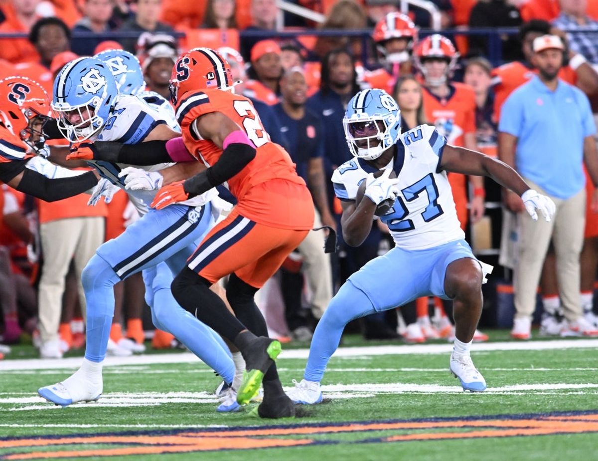 Oct 31, 2025; Syracuse, New York, USA; North Carolina Tar Heels running back Jaylen McGill (27) carries the ball against the Syracuse Orange in the second quarter at the JMA Wireless Dome. Mandatory Credit: Mark Konezny-Imagn Images