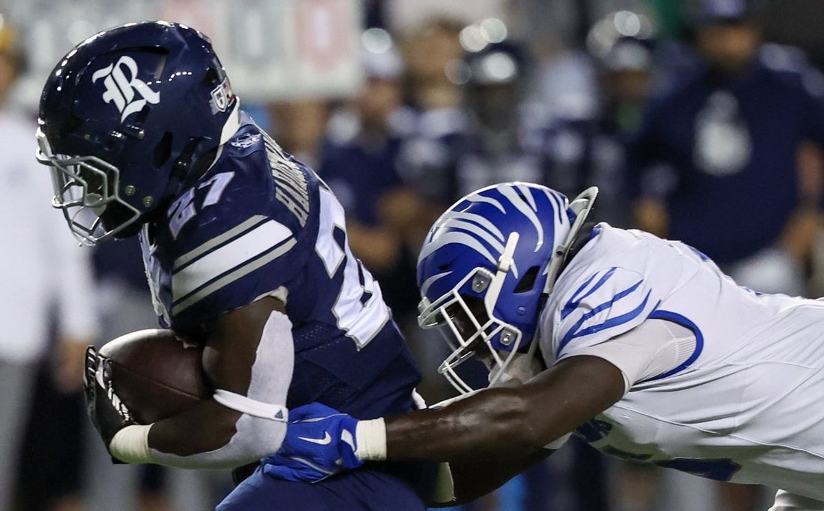 Oct 31, 2025; Houston, Texas, USA; Rice Owls running back D'Andre Hardemann (27) breaks the tackle of Memphis Tigers linebacker Everett Roussaw Jr. (6) in the second half at Rice Stadium. Mandatory Credit: Thomas Shea-Imagn Images
