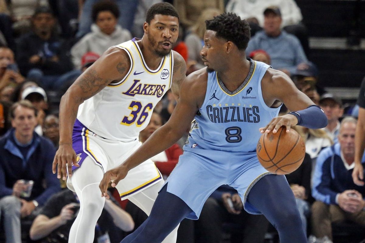 Oct 31, 2025; Memphis, Tennessee, USA; Memphis Grizzlies forward/center Jaren Jackson Jr. (8) dribbles as Los Angeles Lakers guard Marcus Smart (36) defends during the first quarter at FedExForum. Mandatory Credit: Petre Thomas-Imagn Images