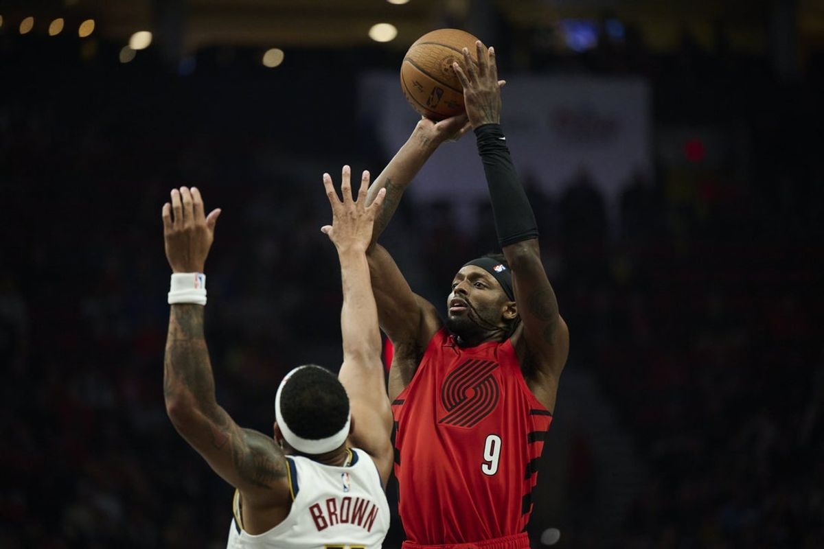 Oct 31, 2025; Portland, Oregon, USA; Portland Trail Blazers forward Jerami Grant (9) shoots a jump shot during the first half against Denver Nuggets guard Bruce Brown (11) at Moda Center. Mandatory Credit: Troy Wayrynen-Imagn Images