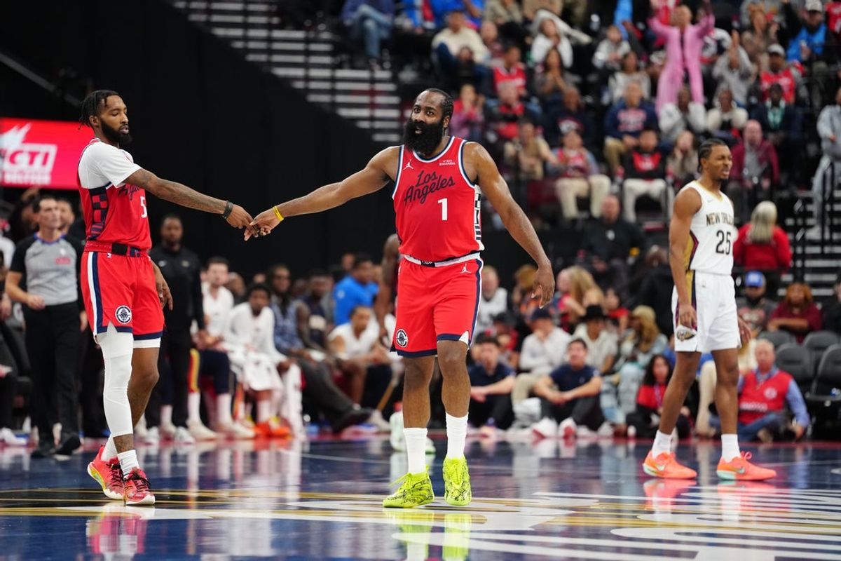 Oct 31, 2025; Inglewood, California, USA; LA Clippers guard James Harden (1) and forward Derrick Jones Jr. (5) celebrate as New Orleans Pelicans forward Trey Murphy III (25) watches in the first half at Intuit Dome. Mandatory Credit: Kirby Lee-Imagn Images