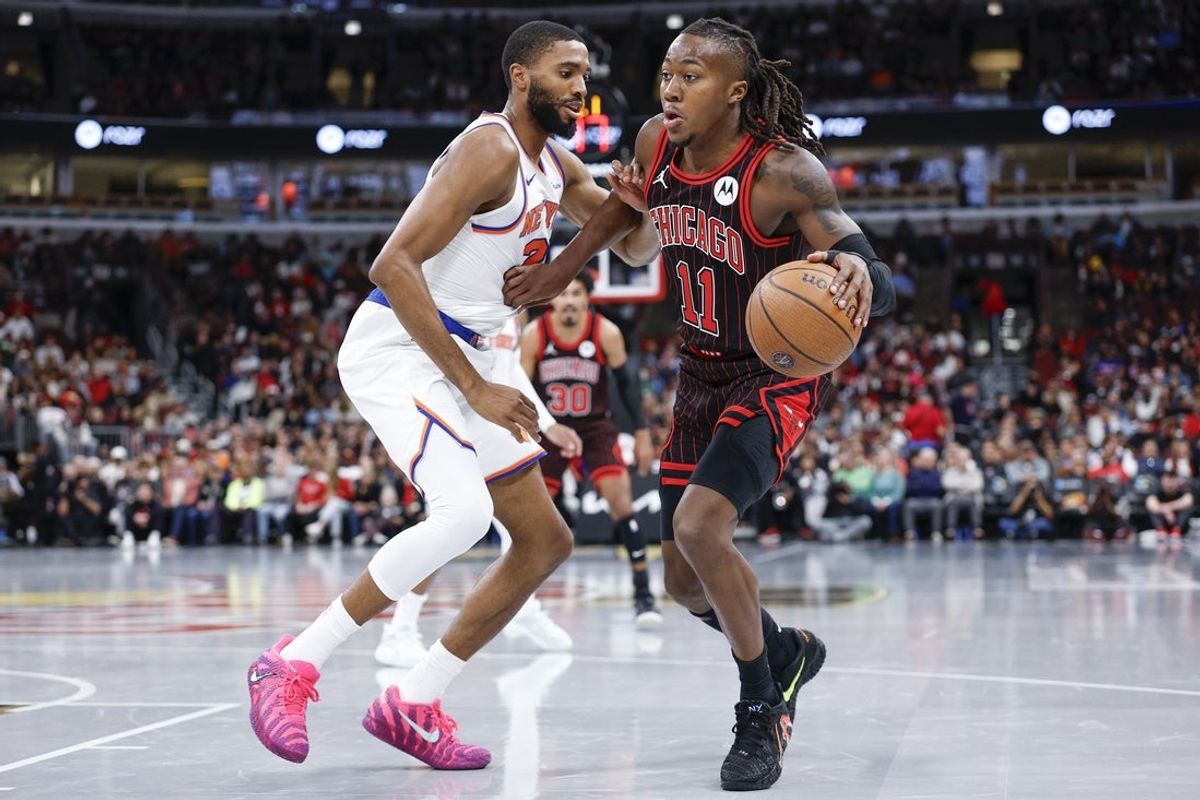 Oct 31, 2025; Chicago, Illinois, USA; Chicago Bulls guard Ayo Dosunmu (11) drives to the basket against New York Knicks guard Mikal Bridges (25) during the first half at United Center. Mandatory Credit: Kamil Krzaczynski-Imagn Images