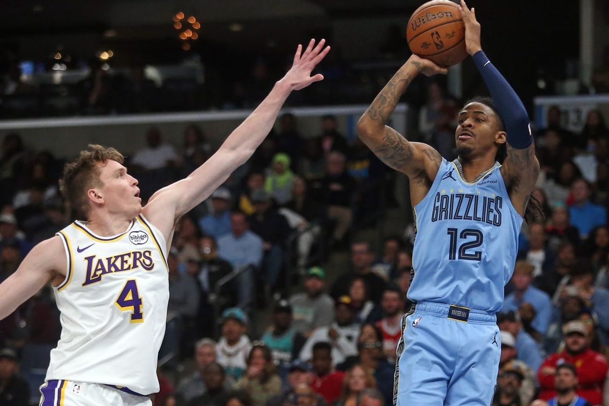 Oct 31, 2025; Memphis, Tennessee, USA; Memphis Grizzlies guard Ja Morant (12) shoots for three as Los Angeles Lakers forward Dalton Knecht (4) defends during the third quarter at FedExForum. Mandatory Credit: Petre Thomas-Imagn Images