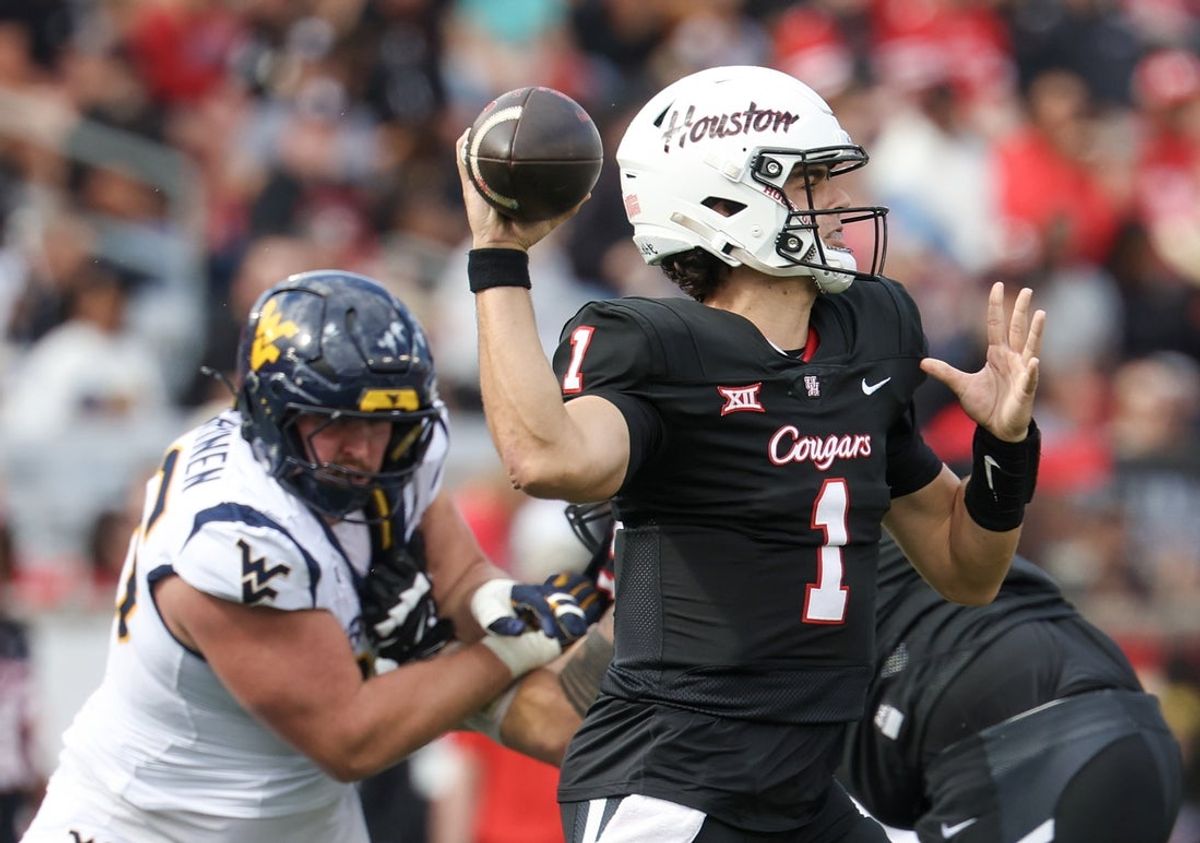 Nov 1, 2025; Houston, Texas, USA; Houston Cougars quarterback Conner Weigman (1) drops back to pass against the West Virginia Mountaineers in the first half at TDECU Stadium. Mandatory Credit: Thomas Shea-Imagn Images