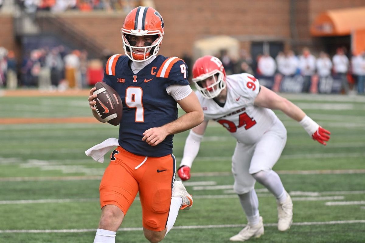 Nov 1, 2025; Champaign, Illinois, USA;  Illinois Fighting Illini quarterback Luke Altmyer (9) scores a touchdown during the first half against the Rutgers Scarlet Knights at Memorial Stadium. Mandatory Credit: Ron Johnson-Imagn Images