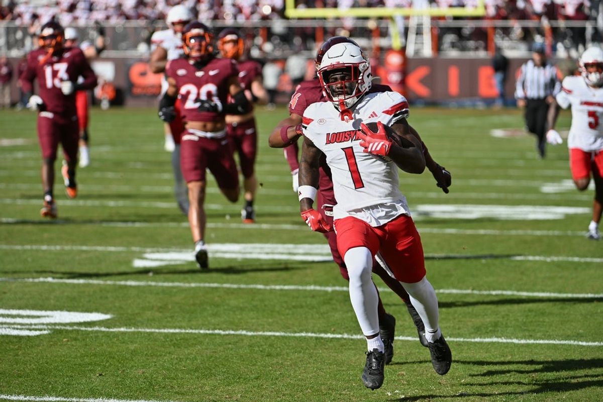 Nov 1, 2025; Blacksburg, Virginia, USA;  Louisville Cardinals running back Isaac Brown (1) runs the ball for a touchdown against the Virginia Tech Hokies during the first quarter at Lane Stadium. Mandatory Credit: Brian Bishop-Imagn Images