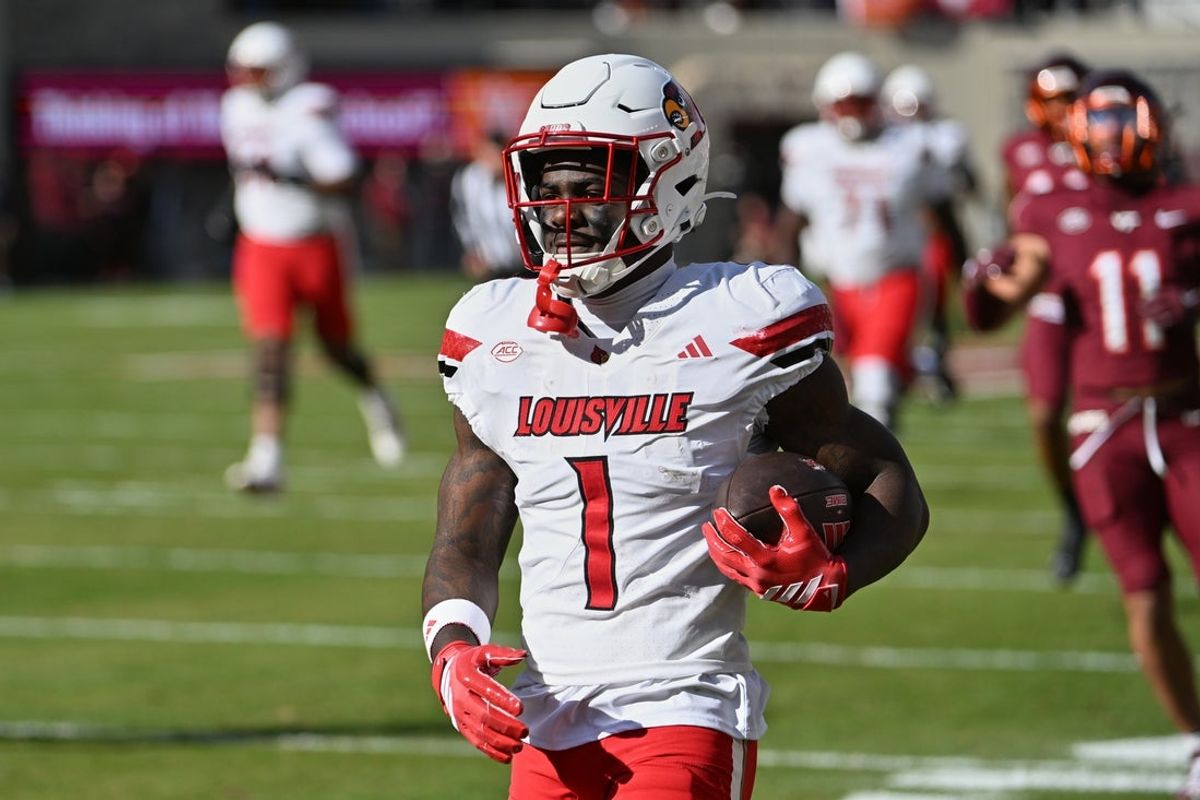 Nov 1, 2025; Blacksburg, Virginia, USA;  Louisville Cardinals running back Isaac Brown (1) reacts after scoring a touchdown against the Virginia Tech Hokies during the first quarter at Lane Stadium. Mandatory Credit: Brian Bishop-Imagn Images