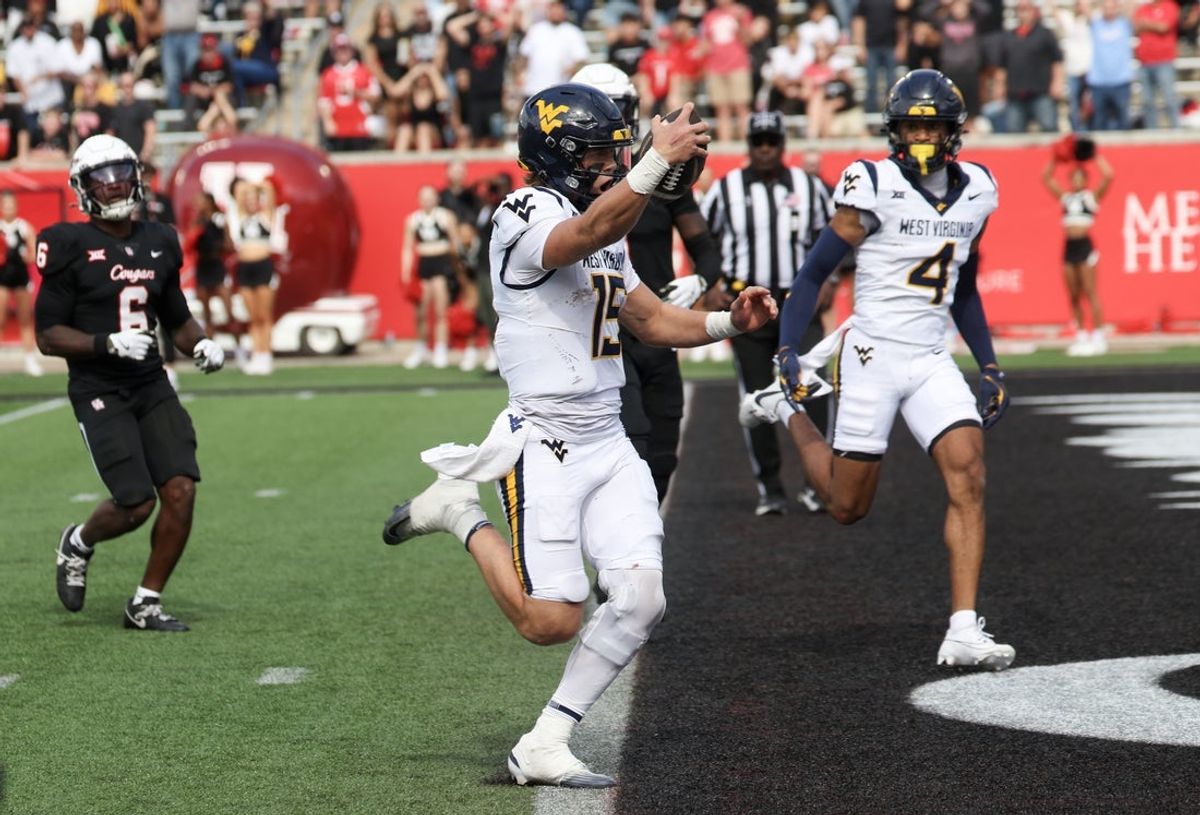Nov 1, 2025; Houston, Texas, USA; West Virginia Mountaineers quarterback Scotty Fox Jr. (15) rushes for a touchdown against the Houston Cougars in the second half at TDECU Stadium. Mandatory Credit: Thomas Shea-Imagn Images