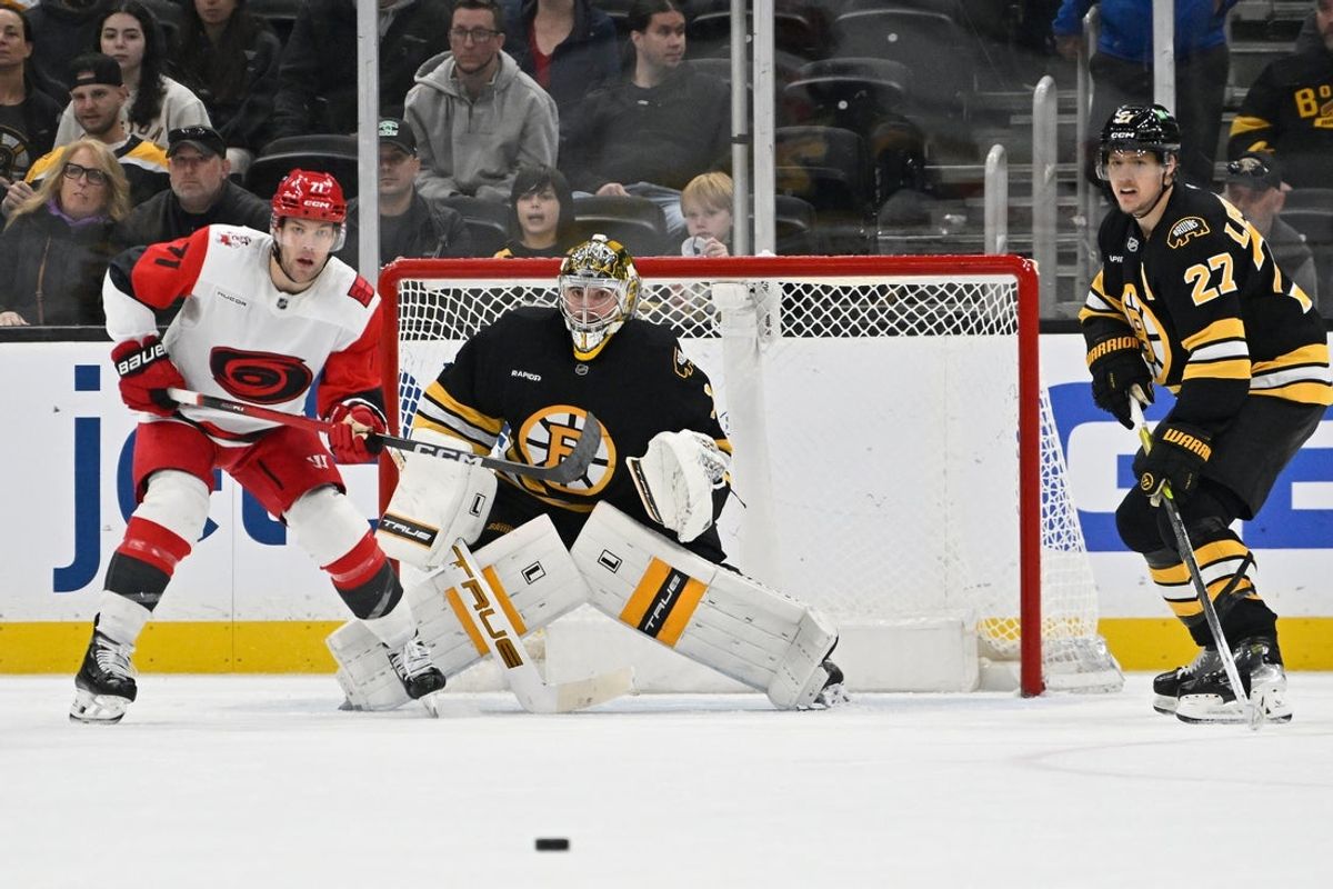 Nov 1, 2025; Boston, Massachusetts, USA; Carolina Hurricanes left wing Taylor Hall (71), Boston Bruins goaltender Jeremy Swayman (1) and defenseman Hampus Lindholm (27) watch the loose puck during the third period at TD Garden. Mandatory Credit: Eric Canha-Imagn Images