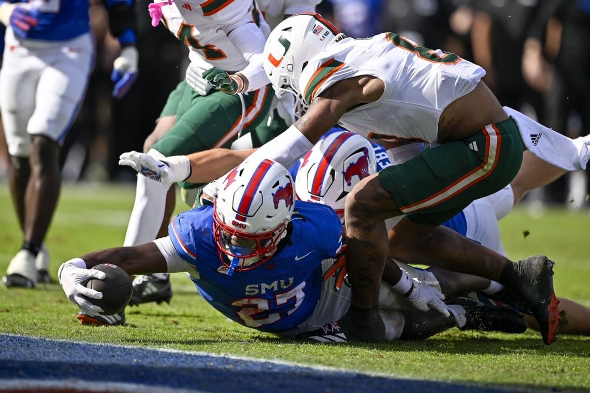 Nov 1, 2025; Dallas, Texas, USA;  SMU Mustangs running back T.J. Harden (27) dives for the goal line during the overtime period against the Miami Hurricanes at Gerald J. Ford Stadium. Mandatory Credit: Jerome Miron-Imagn Images