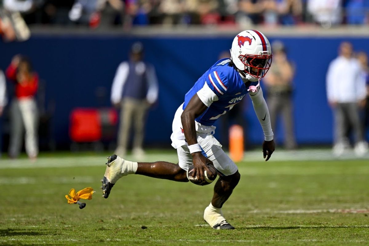 Nov 1, 2025; Dallas, Texas, USA;  A yellow penalty flag files through air as SMU Mustangs quarterback Kevin Jennings (7) runs with the ball against the Miami Hurricanes during the second half at Gerald J. Ford Stadium. Mandatory Credit: Jerome Miron-Imagn Images