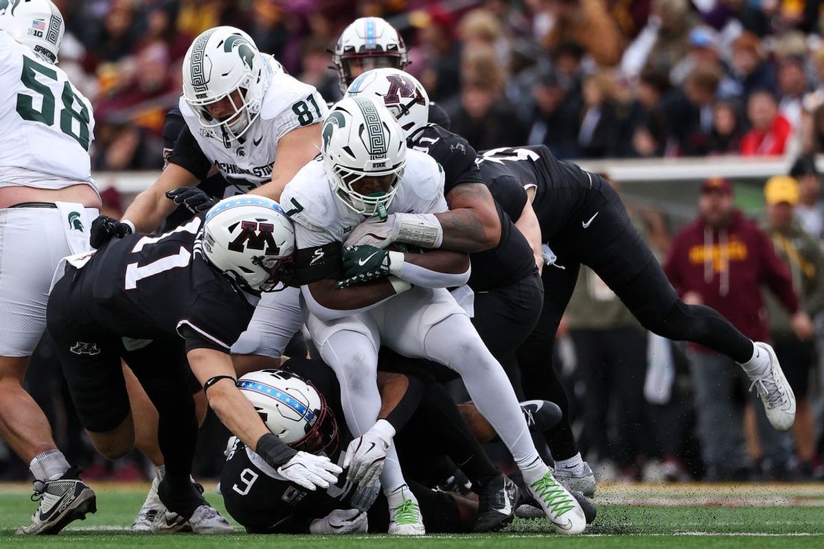 Nov 1, 2025; Minneapolis, Minnesota, USA; Michigan State Spartans running back Brandon Tullis (7) runs the ball against the Minnesota Golden Gophers during the first half at Huntington Bank Stadium. Mandatory Credit: Matt Krohn-Imagn Images