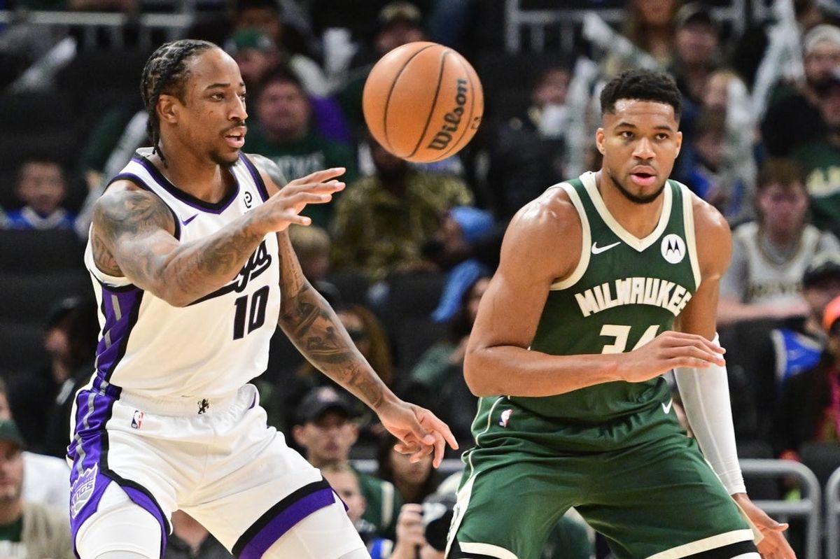 Nov 1, 2025; Milwaukee, Wisconsin, USA; Sacramento Kings forward DeMar DeRozan (10) passes the ball against Milwaukee Bucks forward Giannis Antetokounmpo (34) in the first quarter at Fiserv Forum. Mandatory Credit: Benny Sieu-Imagn Images