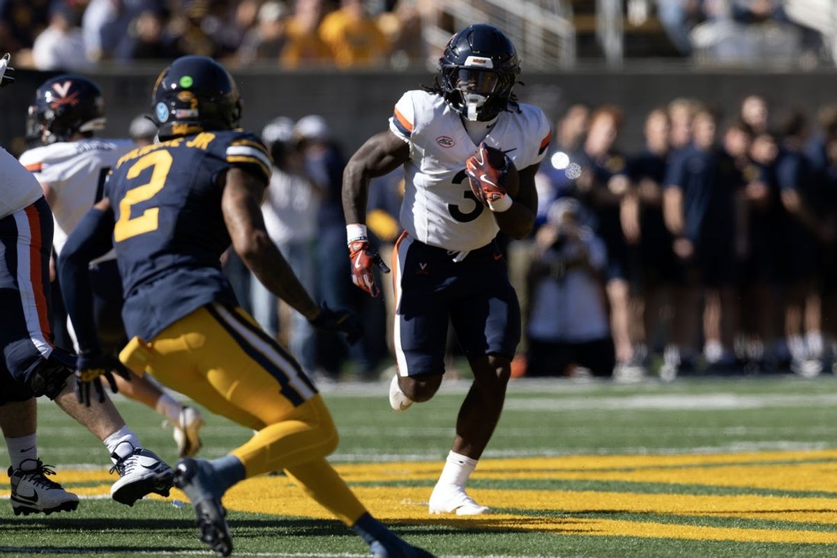 Nov 1, 2025; Berkeley, California, USA; Virginia Cavaliers running back J'Mari Taylor (3) runs the ball against defensive back Dru Polidore Jr. (2) during the first quarter at California Memorial Stadium. Mandatory Credit: D. Ross Cameron-Imagn Images