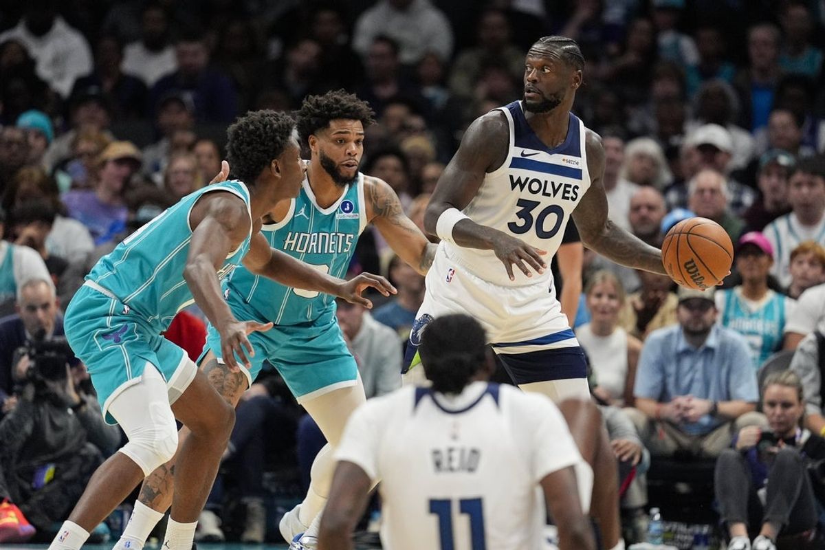 Nov 1, 2025; Charlotte, North Carolina, USA; Minnesota Timberwolves forward Julius Randle (30) looks to pass against Charlotte Hornets forward Miles Bridges (0) and forward Moussa Diabate (14) during the second quarter at Spectrum Center. Mandatory Credit: Jim Dedmon-Imagn Images