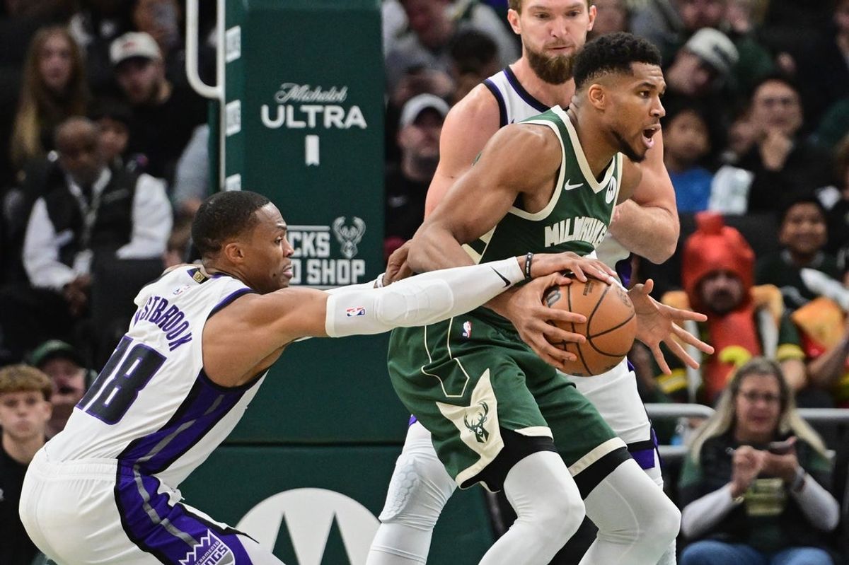 Nov 1, 2025; Milwaukee, Wisconsin, USA;  Sacramento Kings guard Russell Westbrook (18) vies for the ball against Milwaukee Bucks forward Giannis Antetokounmpo (34) in the fourth quarter at Fiserv Forum. Mandatory Credit: Benny Sieu-Imagn Images