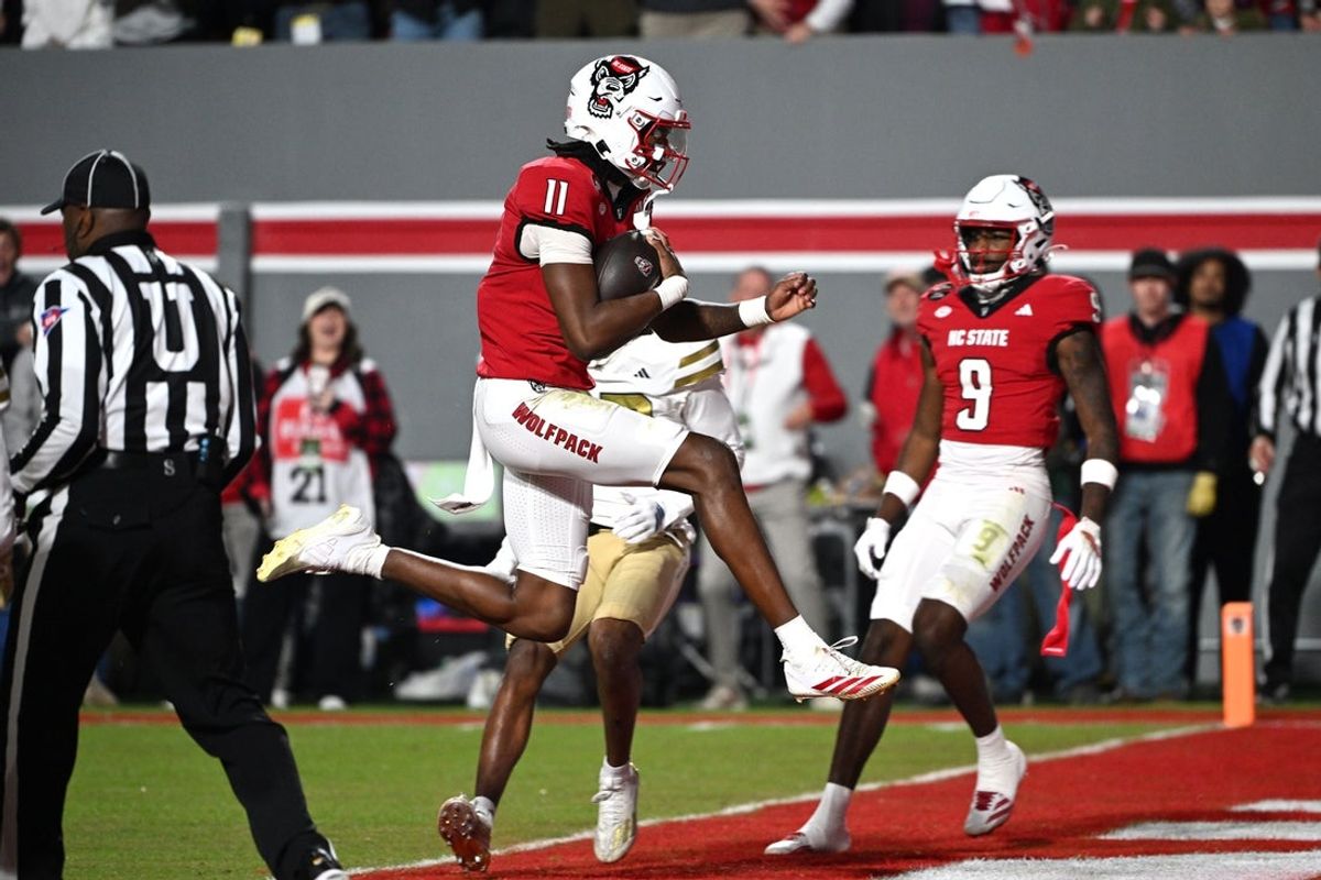 Nov 1, 2025; Raleigh, North Carolina, USA;  North Carolina State Wolfpack quarter back CJ Bailey (11) scores a touchdown against the Georgia Tech Yellow Jackets during the first quarter at Carter-Finley Stadium. Mandatory Credit: Zachary Taft-Imagn Images