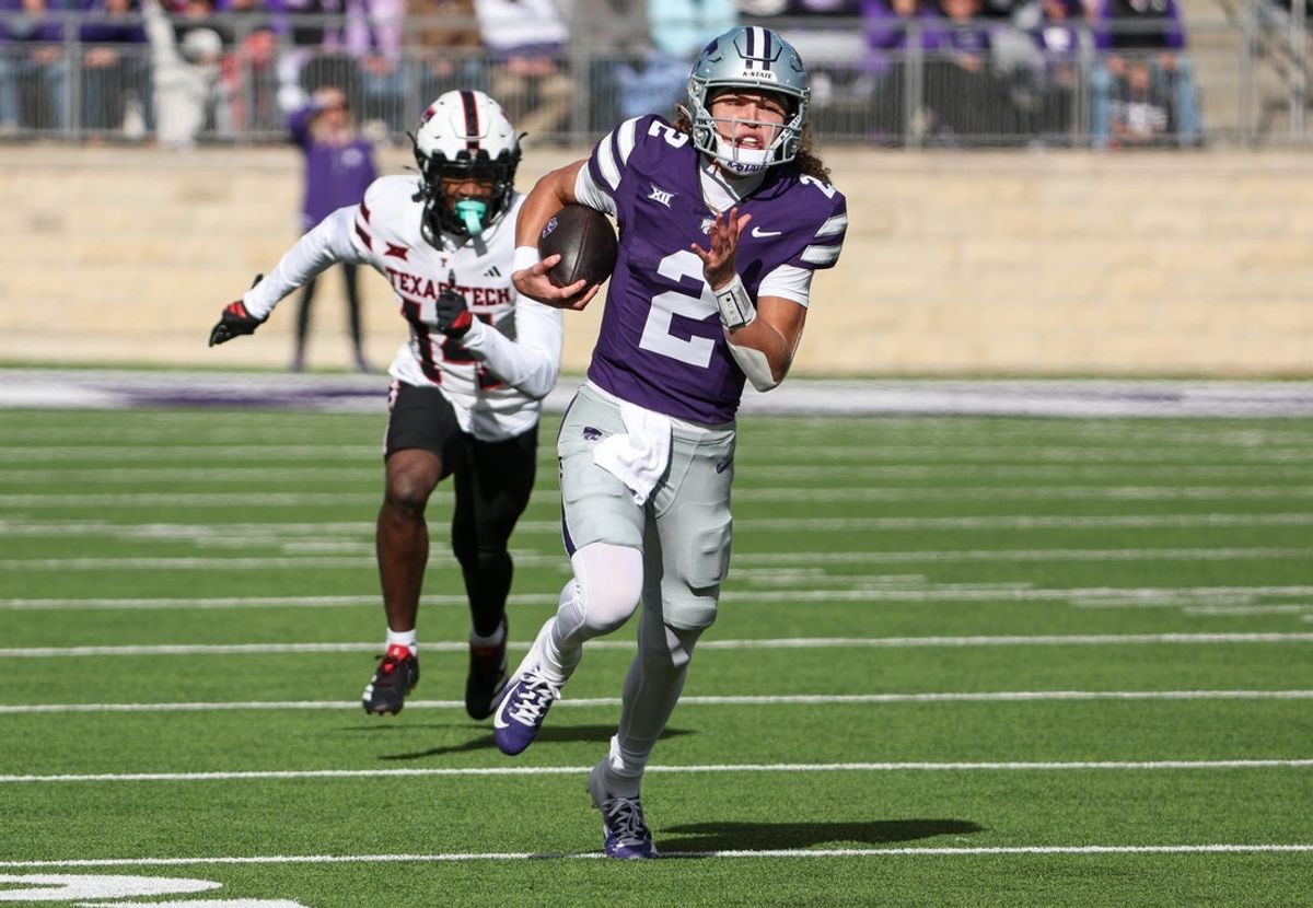 Nov 1, 2025; Manhattan, Kansas, USA; Kansas State Wildcats quarterback Avery Johnson (2) runs with the ball for a touchdown against Texas Tech Red Raiders defensive back Brice Pollock (14) in the first quarter at Bill Snyder Family Football Stadium. Mandatory Credit: Scott Sewell-Imagn Images