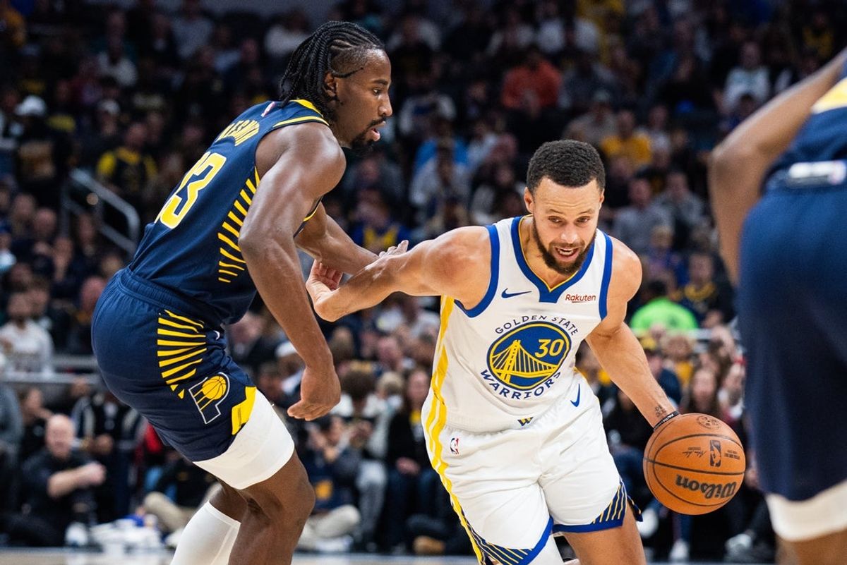 Nov 1, 2025; Indianapolis, Indiana, USA;  Golden State Warriors guard Stephen Curry (30) dribbles the ball while  Indiana Pacers guard/forward Aaron Nesmith (23) defends in the first half  at Gainbridge Fieldhouse. Mandatory Credit: Trevor Ruszkowski-Imagn Images
