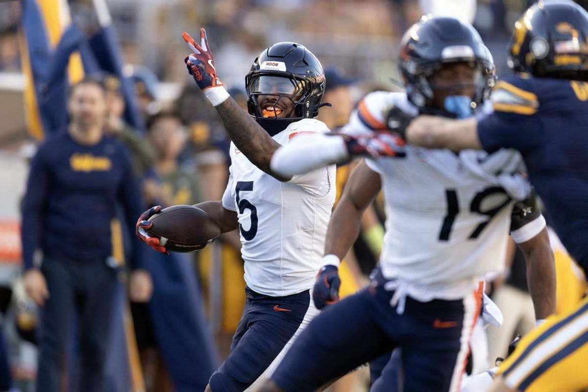 Nov 1, 2025; Berkeley, California, USA; Virginia Cavaliers linebacker Kam Robinson (5) runs back a California Golden Bears quarterback Jaron-Keawe Sagapolutele pass for a touchdown during the fourth quarter at California Memorial Stadium. Mandatory Credit: D. Ross Cameron-Imagn Images