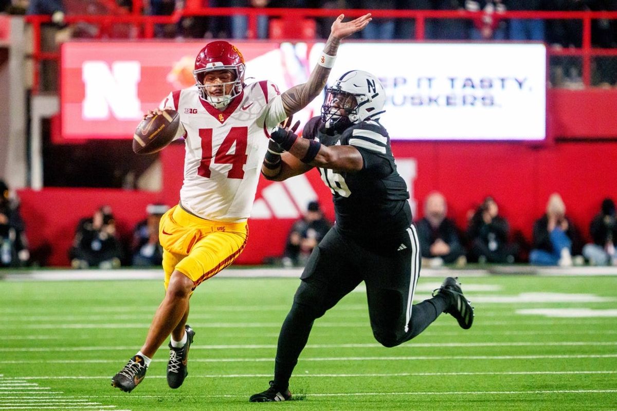 Nov 1, 2025; Lincoln, Nebraska, USA; Southern California Trojans quarterback Jayden Maiava (14) runs against Nebraska Cornhuskers defensive lineman Elijah Jeudy (16) during the second quarter at Memorial Stadium. Mandatory Credit: Dylan Widger-Imagn Images