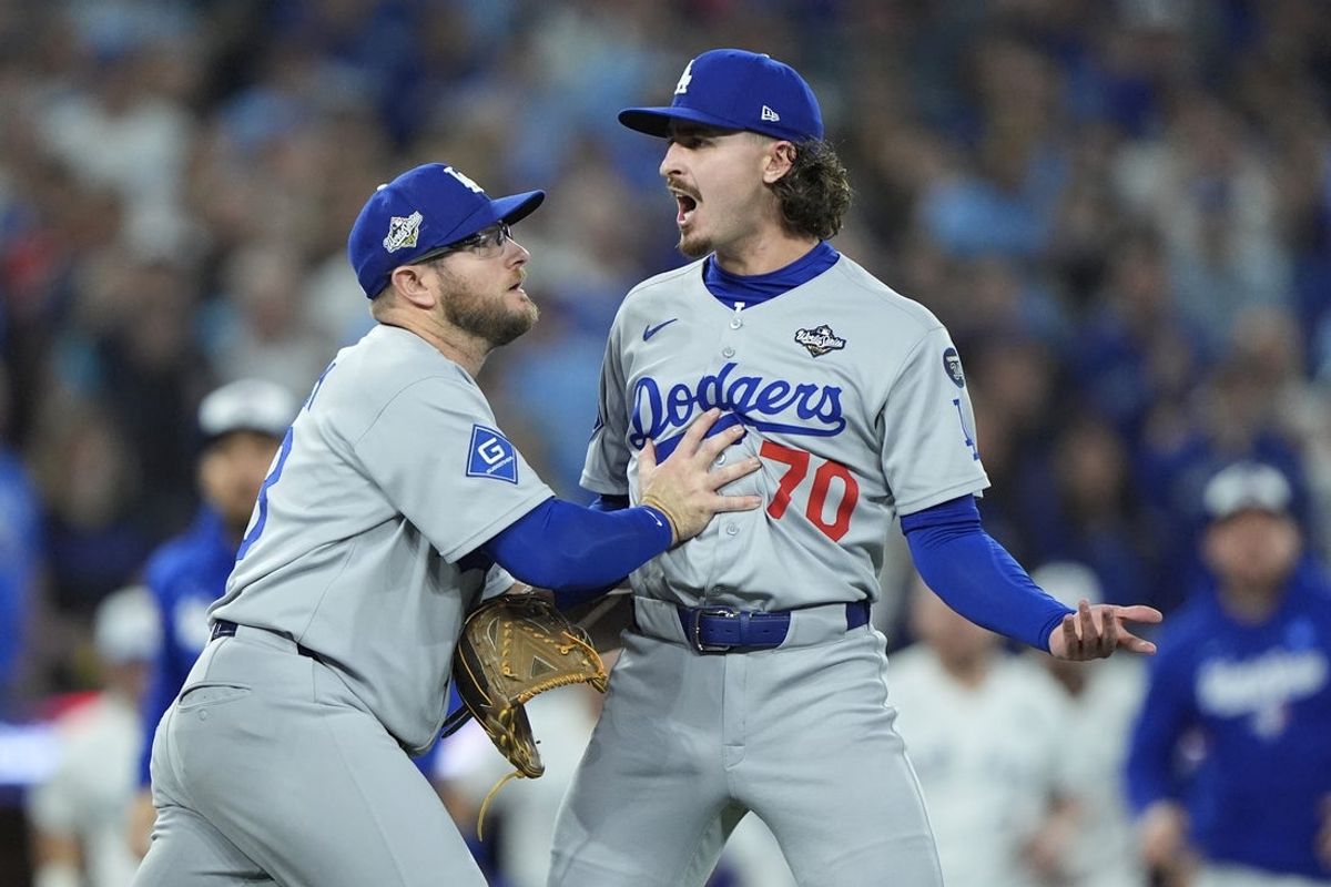 Nov 1, 2025; Toronto, Ontario, CAN; Los Angeles Dodgers third baseman Max Muncy (13) and pitcher Justin Wrobleski (70) react after Toronto Blue Jays shortstop Andres Gimenez (0) is hit by a pitch in the fourth inning during game seven of the 2025 MLB World Series at Rogers Centre. Mandatory Credit: John E. Sokolowski-Imagn Images