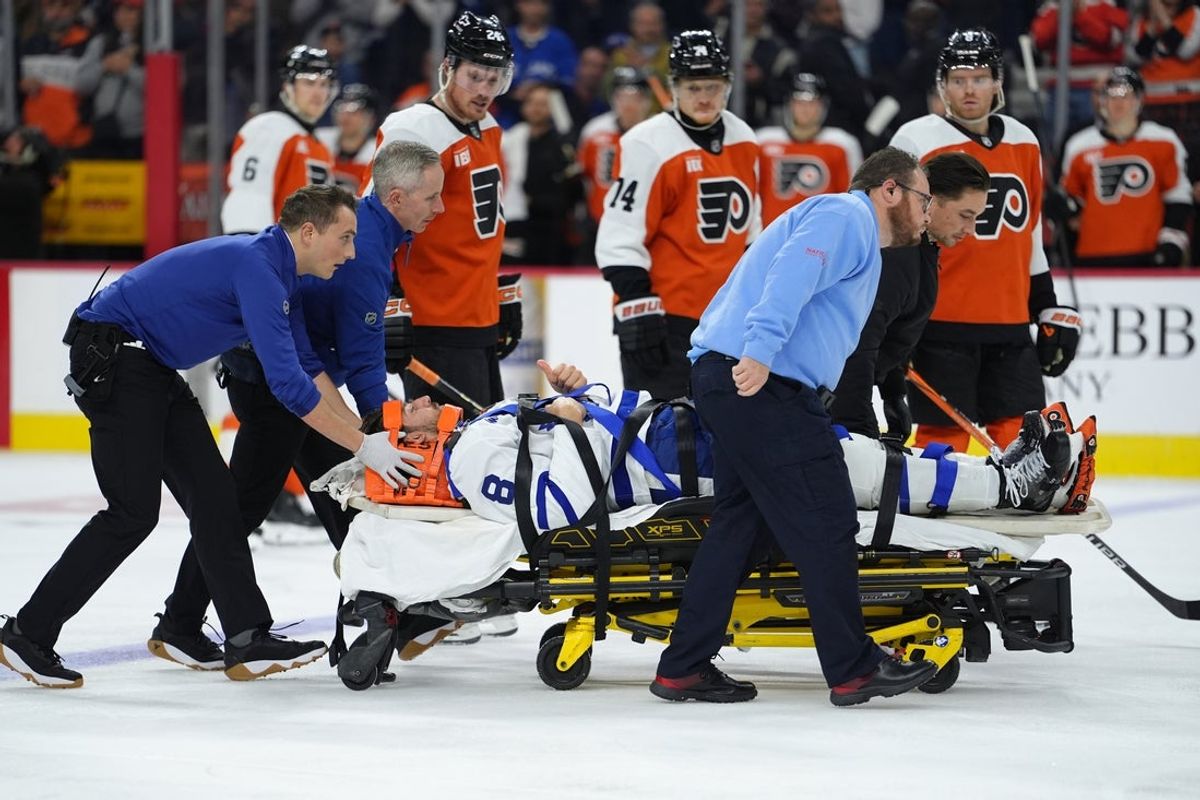 Nov 1, 2025; Philadelphia, Pennsylvania, USA; Toronto Maple Leafs defenseman Chris Tanev (8) reacts as he is assisted off the ice after an injury against the Philadelphia Flyers in the third period at Xfinity Mobile Arena. Mandatory Credit: Kyle Ross-Imagn Images