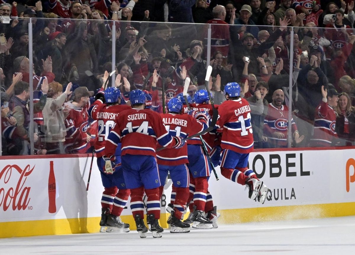 Nov 1, 2025; Montreal, Quebec, CAN; Montreal Canadiens forward Alex Newhook (15) celebrates with teammates after scoring the winning goal against the Ottawa Senators during the overtime period at the Bell Centre. Mandatory Credit: Eric Bolte-Imagn Images