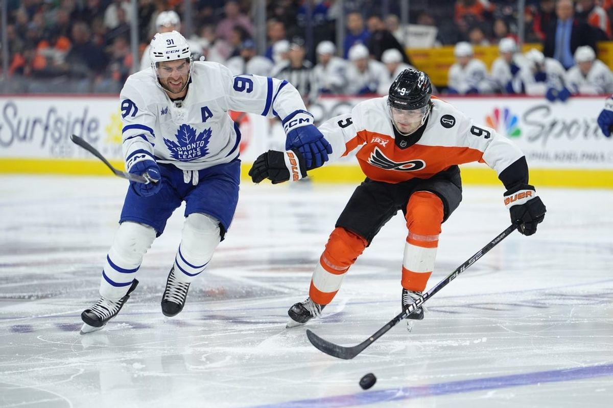 Nov 1, 2025; Philadelphia, Pennsylvania, USA; Toronto Maple Leafs center John Tavares (91) and Philadelphia Flyers defenseman Jamie Drysdale (9) battle for the puck in the third period at Xfinity Mobile Arena. Mandatory Credit: Kyle Ross-Imagn Images