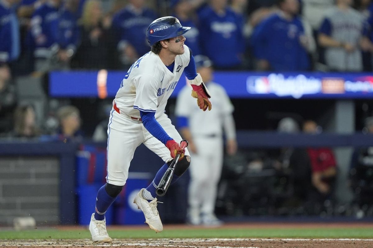 Nov 1, 2025; Toronto, Ontario, CAN; Toronto Blue Jays third baseman Ernie Clement (22) hits a double against the Los Angeles Dodgers in the eighth inning during game seven of the 2025 MLB World Series at Rogers Centre. Mandatory Credit: John E. Sokolowski-Imagn Images