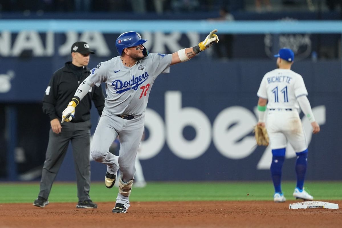 Nov 1, 2025; Toronto, Ontario, CAN; Los Angeles Dodgers second baseman Miguel Rojas (72) reacts after hitting a home run against the Toronto Blue Jays  in the ninth inning for game seven of the 2025 MLB World Series at Rogers Centre. Mandatory Credit: Nick Turchiaro-Imagn Images