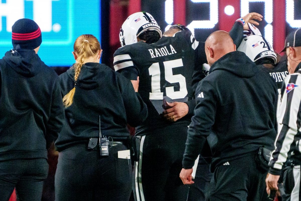 Nov 1, 2025; Lincoln, Nebraska, USA; Nebraska Cornhuskers quarterback Dylan Raiola (15) is helped off the field after being injured against the Southern California Trojans during the third quarter at Memorial Stadium. Mandatory Credit: Dylan Widger-Imagn Images