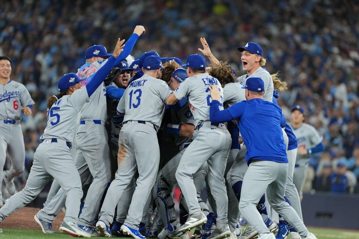 Nov 1, 2025; Toronto, Ontario, CAN; The Los Angeles Dodgers react after defeating the Toronto Blue Jays in the eleventh inning for game seven of the 2025 MLB World Series at Rogers Centre. Mandatory Credit: Nick Turchiaro-Imagn Images