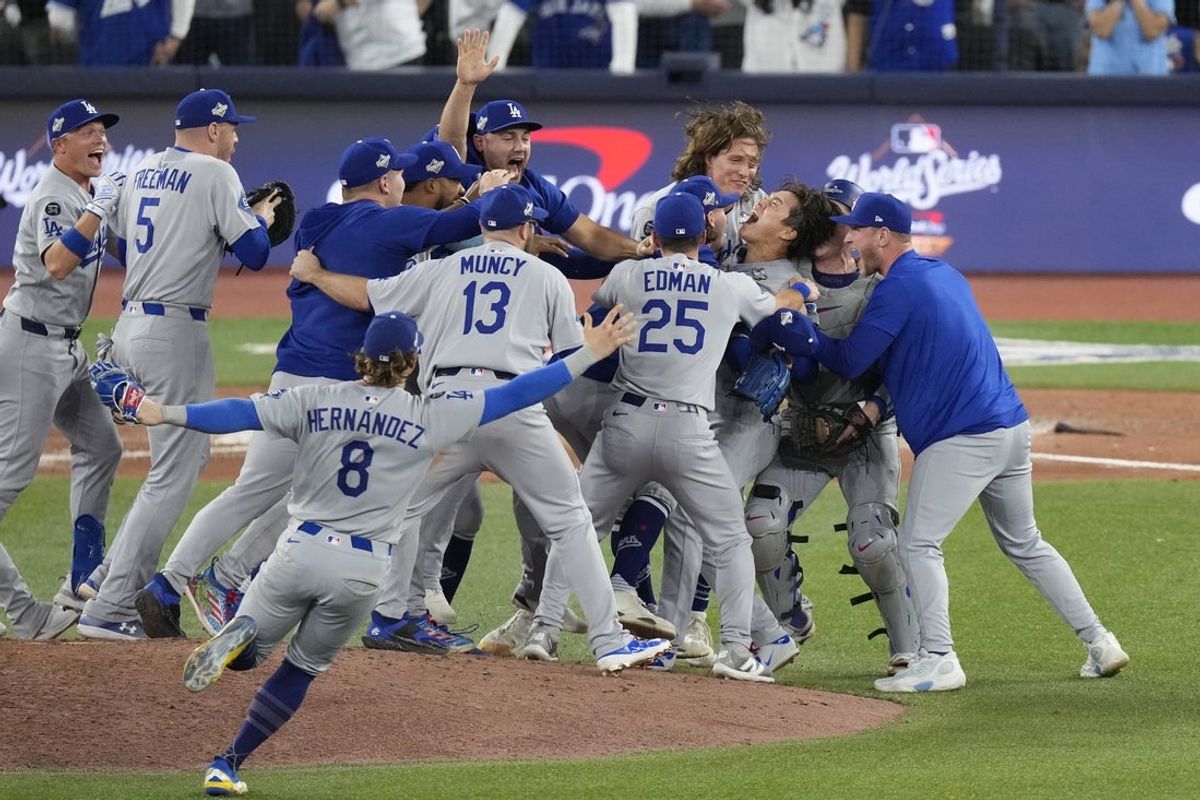 Nov 1, 2025; Toronto, Ontario, CAN; Los Angeles Dodgers pitcher Yoshinobu Yamamoto (18) celebrates with teammates after defeating the Toronto Blue Jays in game seven of the 2025 MLB World Series at Rogers Centre. Mandatory Credit: Kevin Sousa-Imagn Images