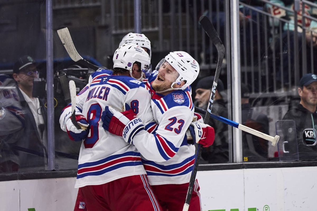 Nov 1, 2025; Seattle, Washington, USA;  New York Rangers defenseman Adam Fox (23) celebrates with New York Rangers center J.T. Miller (8) and New York Rangers left wing Will Cuylle (50) after an overtime win against the Seattle Kraken at Climate Pledge Arena. Mandatory Credit: Blake Dahlin-Imagn Images