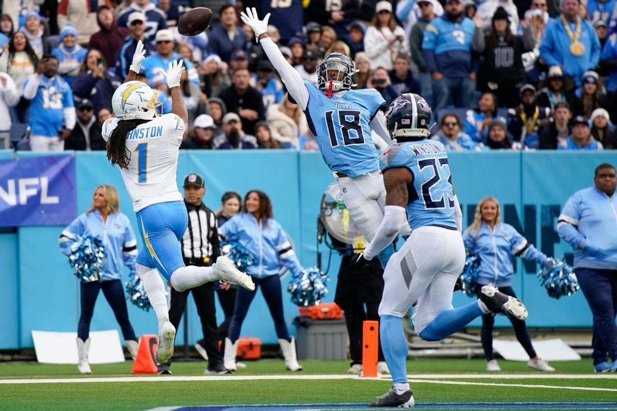 Los Angeles Chargers wide receiver Quentin Johnston (1) receives a pass for a touchdown over Tennessee Titans cornerback Jalyn Armour-Davis (18) during the second quarter at Nissan Stadium in Nashville, Tenn., Sunday, Nov. 2, 2025.