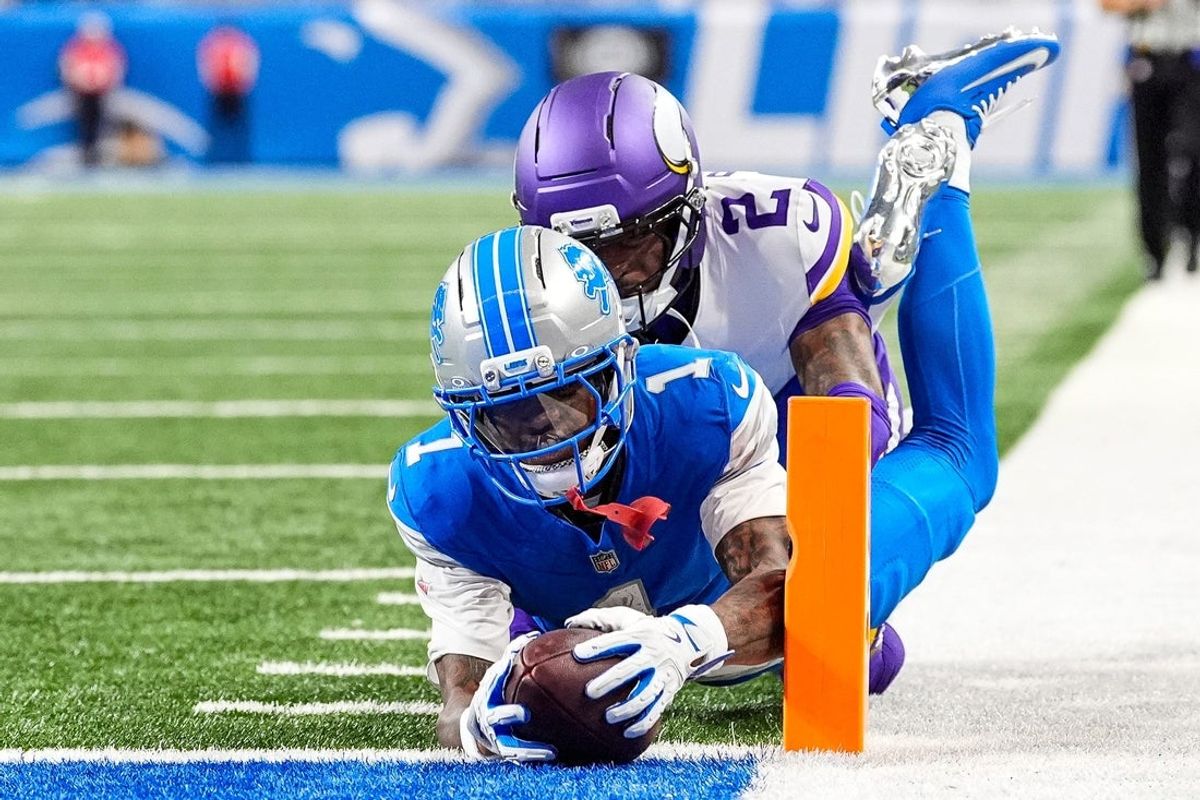 Detroit Lions wide receiver Jameson Williams (1) dives for a touchdown against Minnesota Vikings cornerback Isaiah Rodgers (2) during the second half at Ford Field in Detroit on Sunday, November 2, 2025.