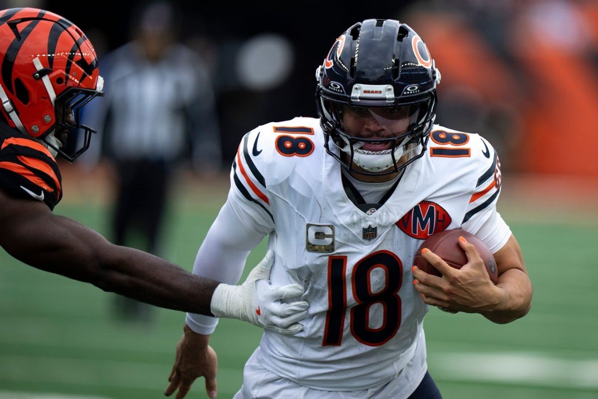 Chicago Bears quarterback Caleb Williams (18) runs by Cincinnati Bengals linebacker Oren Burks (42) in the fourth quarter of the NFL football game between Chicago Bears and Cincinnati Bengals at Paycor Stadium in Cincinnati on Nov. 2, 2025.