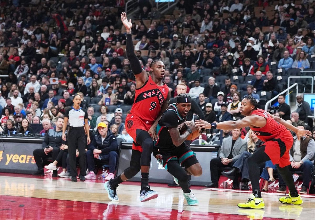 Nov 2, 2025; Toronto, Ontario, CAN; Memphis Grizzlies guard Kentavious Caldwell-Pope (3) drives to the basket between Toronto Raptors forward RJ Barrett (9) and forward Scottie Barnes (4) during the first quarter at Scotiabank Arena. Mandatory Credit: Nick Turchiaro-Imagn Images