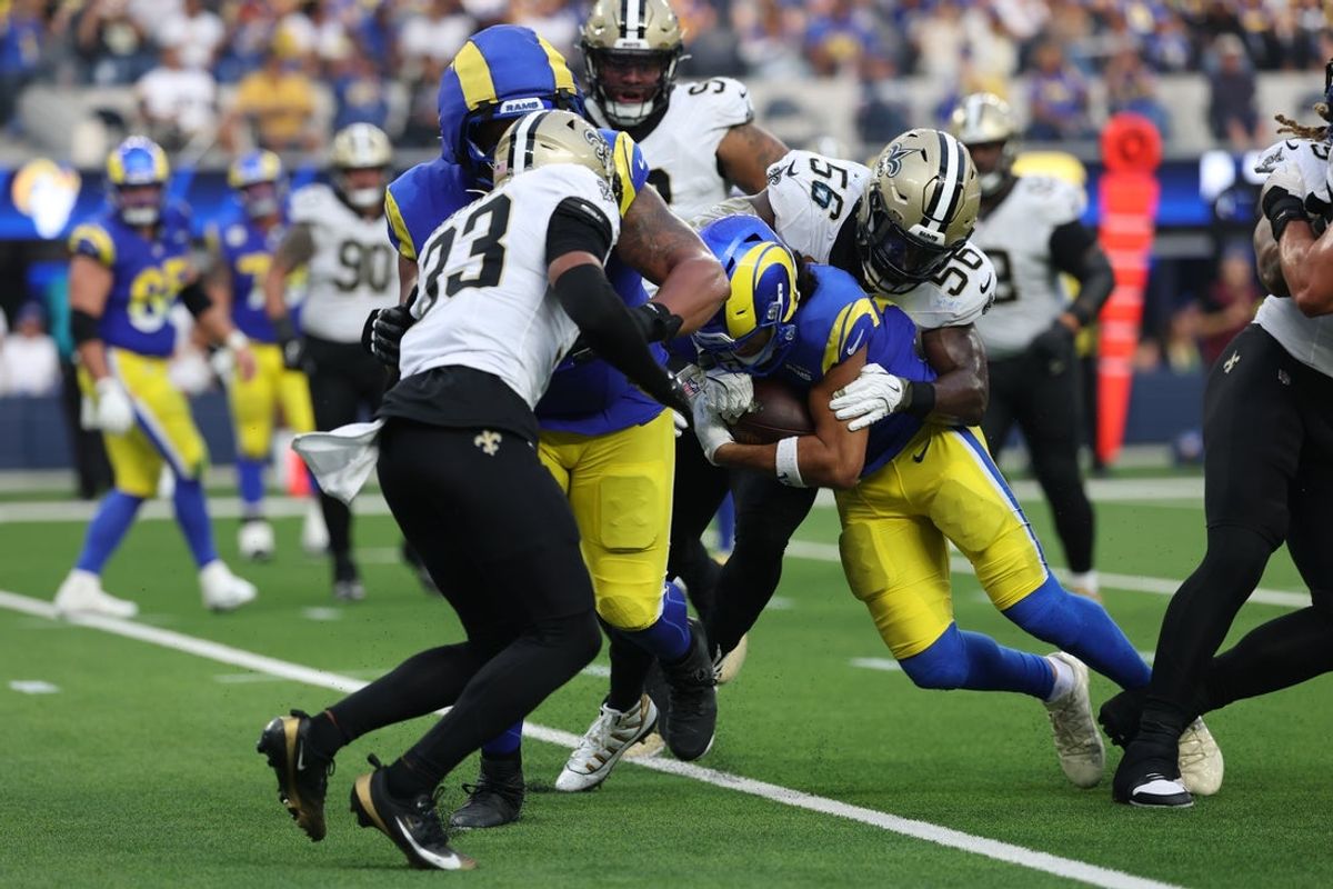 Nov 2, 2025; Inglewood, California, USA; Los Angeles Rams wide receiver Puka Nacua (12) is tackled by. New Orleans Saints linebacker Demario Davis (56) during the second half at SoFi Stadium. Mandatory Credit: Kiyoshi Mio-Imagn Images