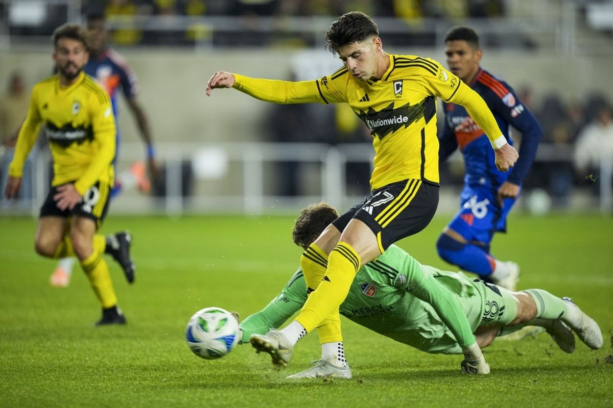 Nov 2, 2025; Columbus, Ohio, USA;  Columbus Crew forward Max Arfsten (27) scores a goal against FC Cincinnati goalkeeper Roman Celentano (18) in the first half at Lower.com Field. Mandatory Credit: Aaron Doster-Imagn Images