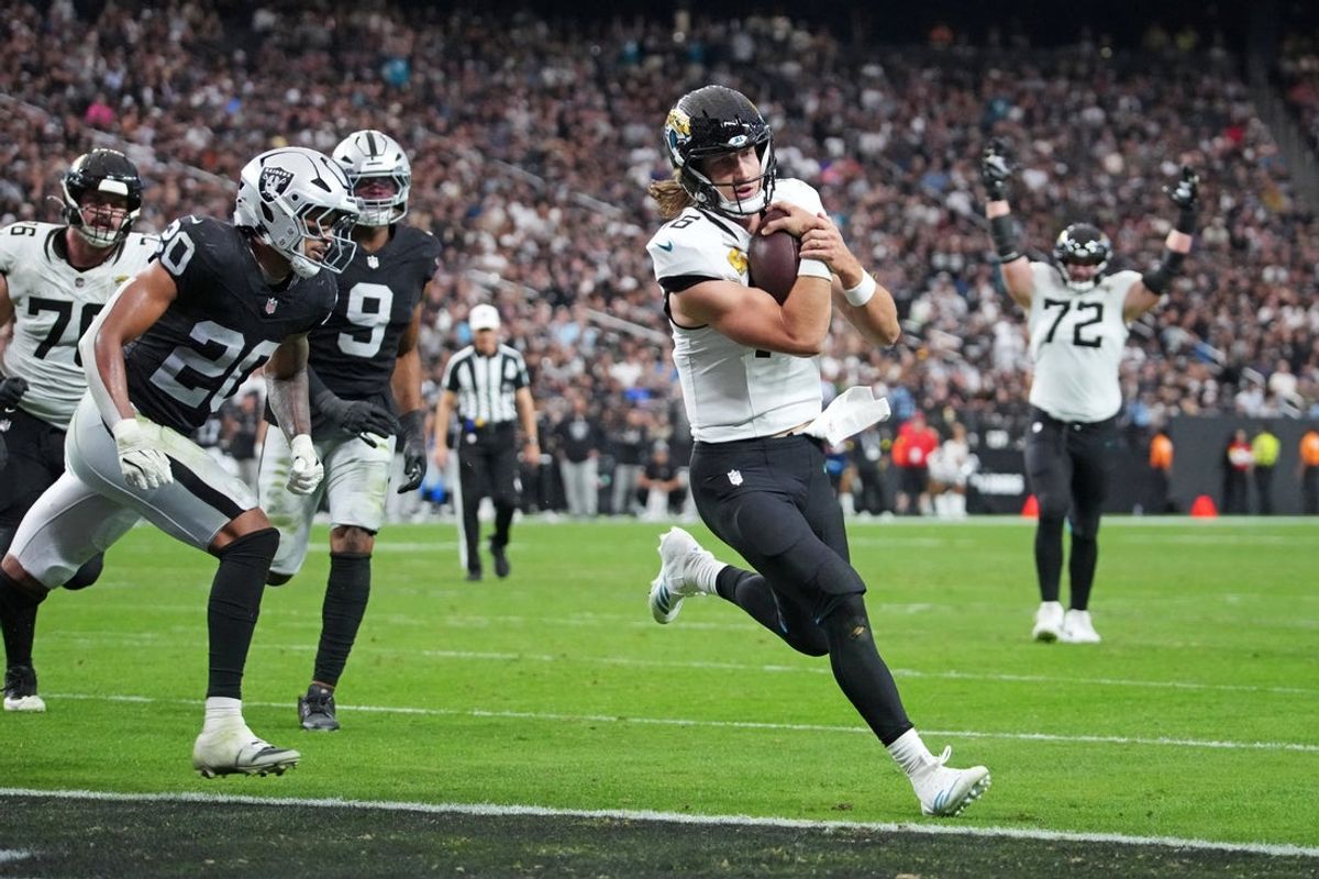Nov 2, 2025; Paradise, Nevada, USA; Jacksonville Jaguars quarterback Trevor Lawrence (16) scores a touchdown during the second half against the Las Vegas Raiders at Allegiant Stadium. Mandatory Credit: Kirby Lee-Imagn Images