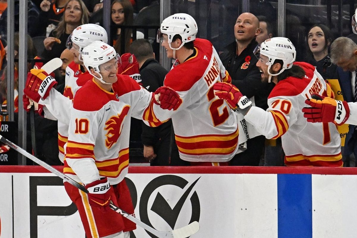 Nov 2, 2025; Philadelphia, Pennsylvania, USA; Calgary Flames left wing Jonathan Huberdeau (10) celebrates his goal with teammates against the Philadelphia Flyers during the second period at Xfinity Mobile Arena. Mandatory Credit: Eric Hartline-Imagn Images