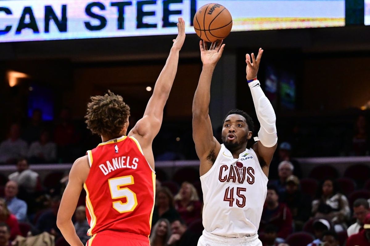 Nov 2, 2025; Cleveland, Ohio, USA; Cleveland Cavaliers guard Donovan Mitchell (45) shoots over the defense of  Atlanta Hawks guard Dyson Daniels (5) during the second half at Rocket Arena. Mandatory Credit: Ken Blaze-Imagn Images