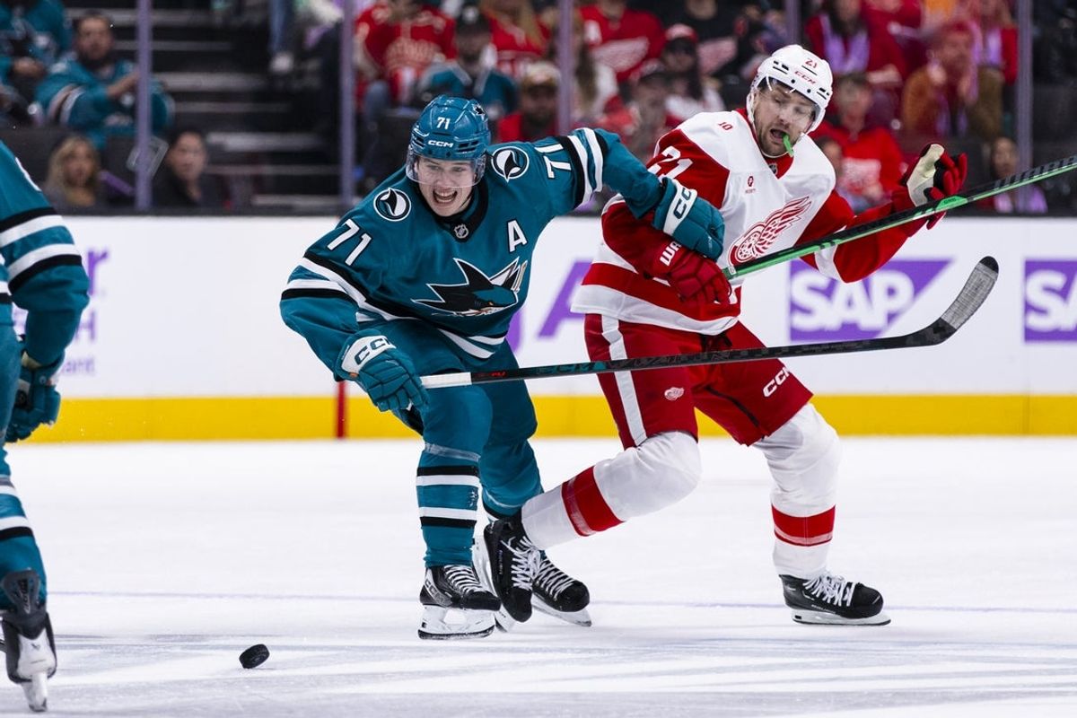 Nov 2, 2025; San Jose, California, USA;  San Jose Sharks center Macklin Celebrini (71) and Detroit Red Wings left wing James van Riemsdyk (21) chase the puck during the second period at SAP Center at San Jose. Mandatory Credit: John Hefti-Imagn Images