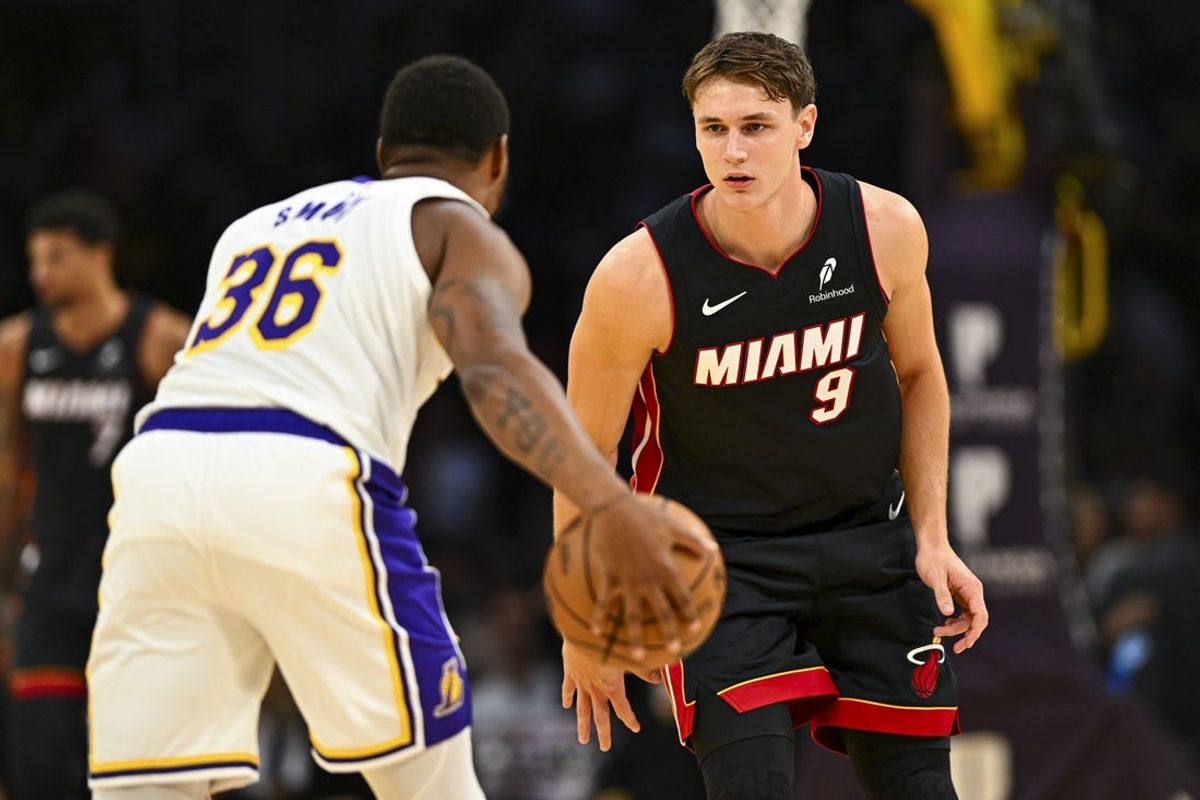 Nov 2, 2025; Los Angeles, California, USA; Miami Heat guard Pelle Larsson (9) defends against Los Angeles Lakers guard Marcus Smart (36) during the first half at Crypto.com Arena. Mandatory Credit: Jonathan Hui-Imagn Images