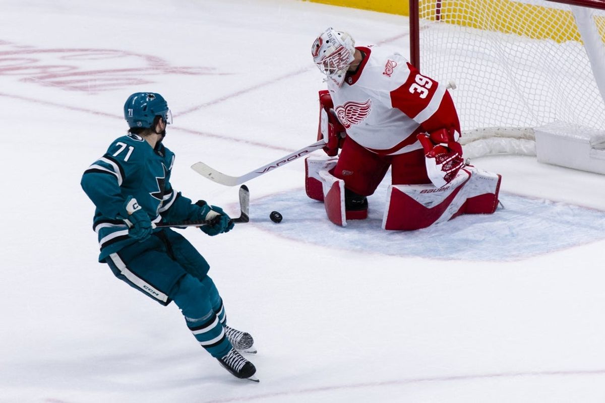 Nov 2, 2025; San Jose, California, USA;  Detroit Red Wings goaltender Cam Talbot (39) deflects a shot by San Jose Sharks center Macklin Celebrini (71) during the shootout at SAP Center at San Jose. Mandatory Credit: John Hefti-Imagn Images