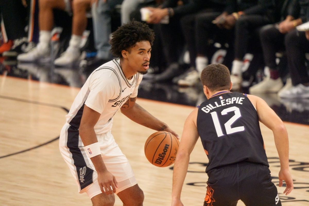 Nov 2, 2025; Phoenix, Arizona, USA;  San Antonio Spurs guard Dylan Harper (2) brings the ball down court as Phoenix Suns guard Collin Gillespie (12) defends during the first half of a game at PHX Arena. Mandatory Credit: Allan Henry-Imagn Images