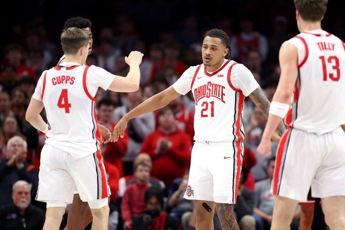 Nov 3, 2025; Columbus, Ohio, USA;  Ohio State Buckeyes forward Devin Royal (21) celebrates with guard Gabe Cupps (4) after converting a basket and foul during the first half against the IU Indy Jaguars at Value City Arena. Mandatory Credit: Joseph Maiorana-Imagn Images